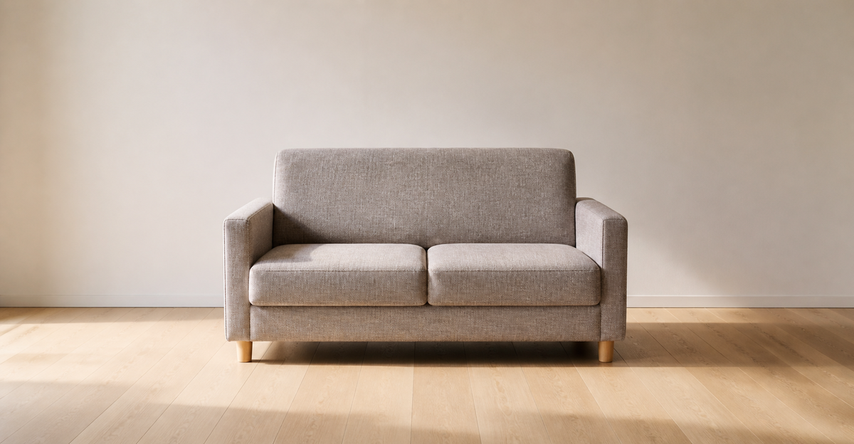 何もない部屋に置かれた二人掛けの布張りソファ